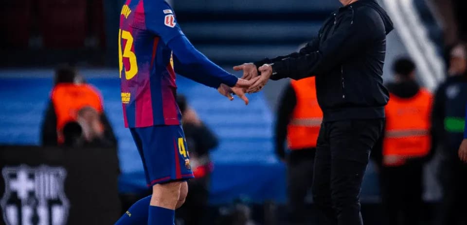 Player shaking hands with coach during substitution