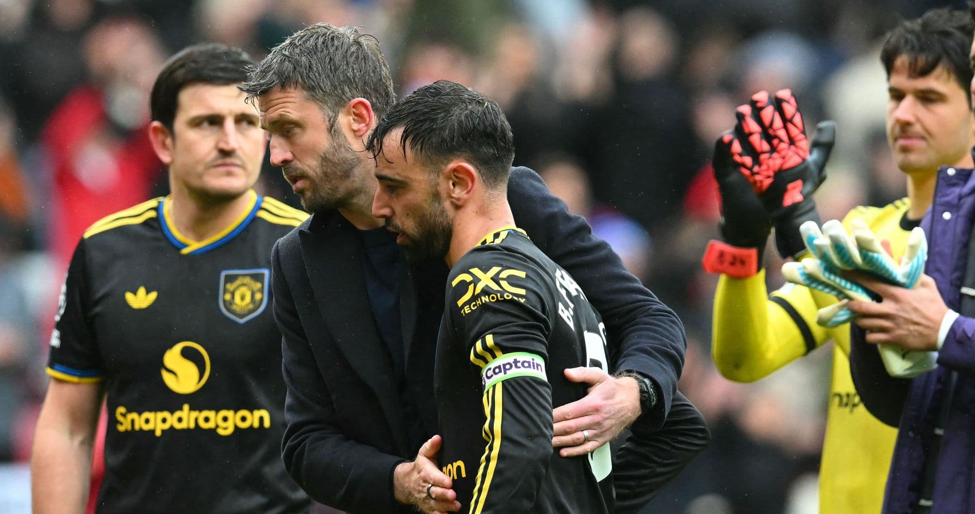 Manager comforting player after match on field