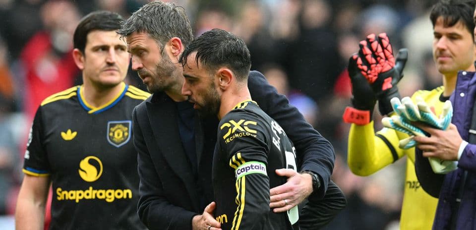 Manager comforting player after match on field