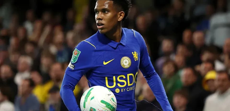 Player in blue jersey holding soccer ball during match