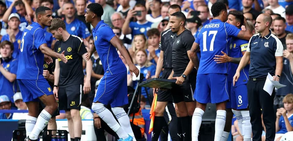 Players greeting each other during substitution on field