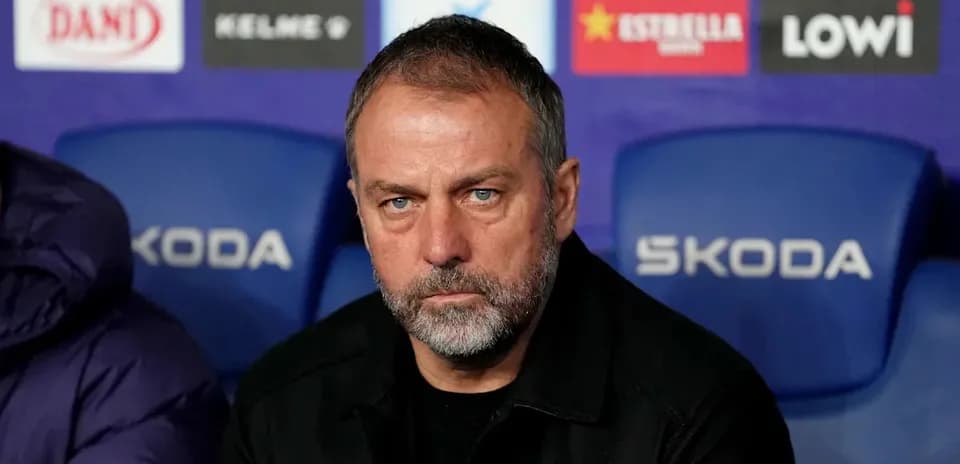 Manager seated on bench during match