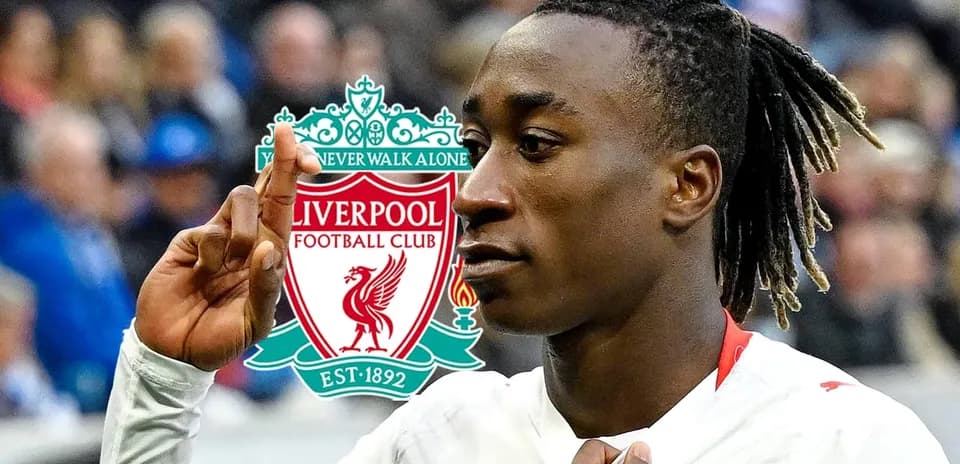 Player celebrating with Liverpool logo in background