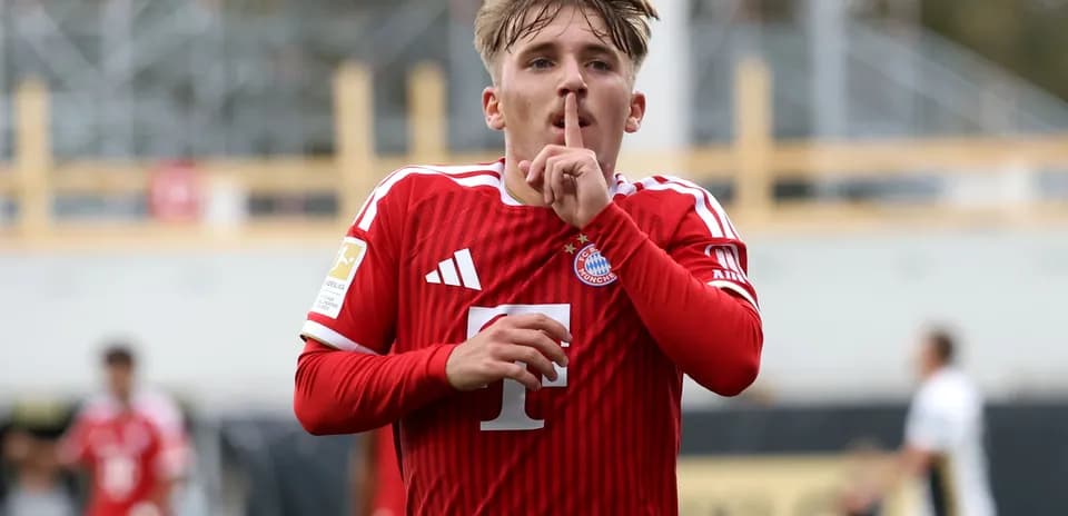 Player celebrating with a shushing gesture after scoring