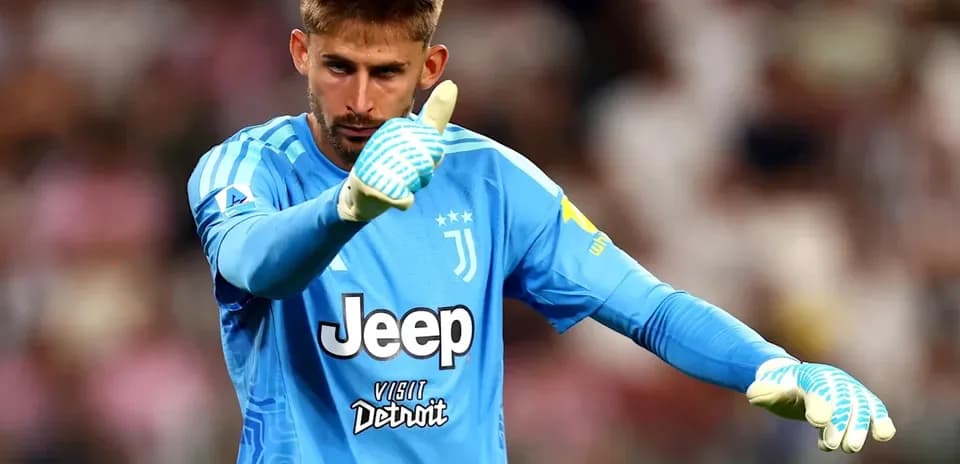 Goalkeeper in blue kit giving thumbs up gesture