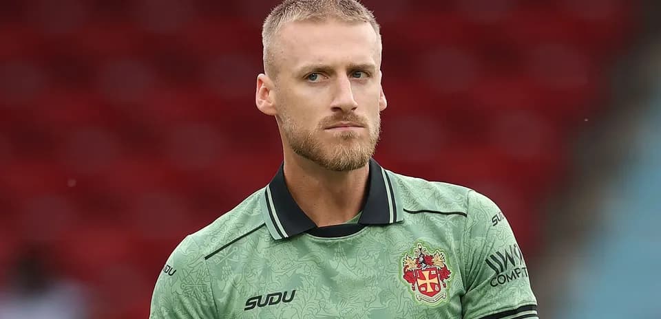 Goalkeeper wearing green kit before match