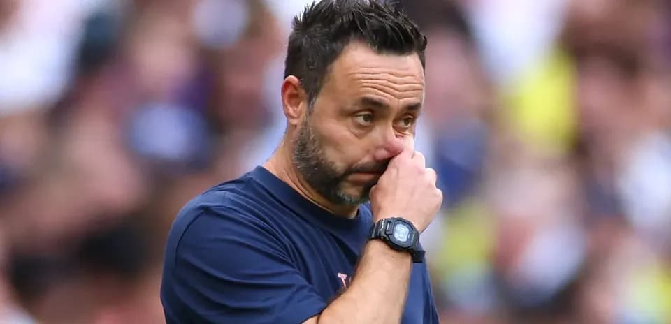 Coach touching his face during match