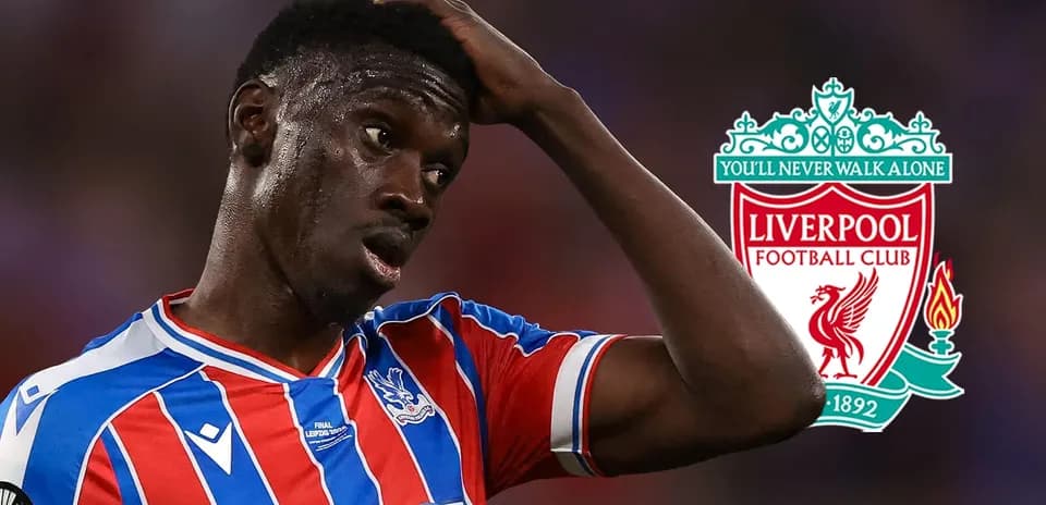 Crystal Palace player reacting during match with Liverpool logo