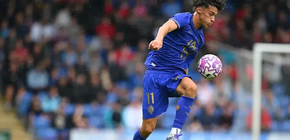 Player in blue kit controlling ball during match