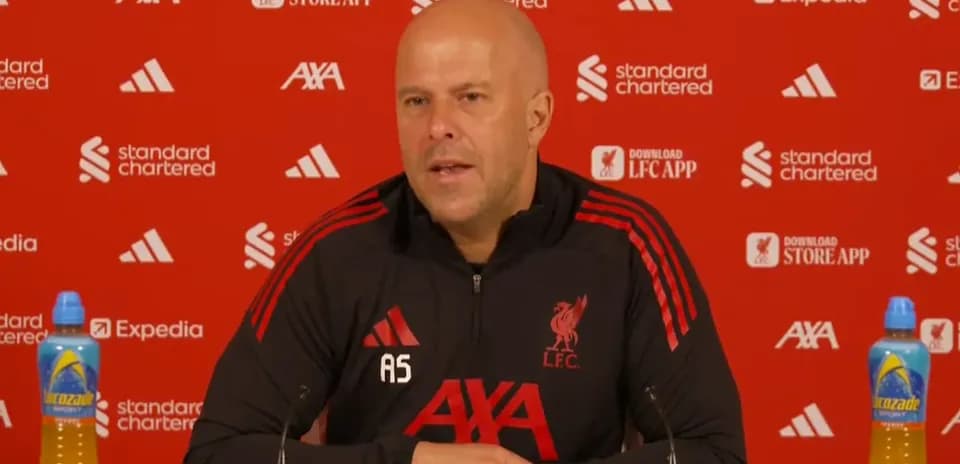Liverpool manager speaking at press conference podium