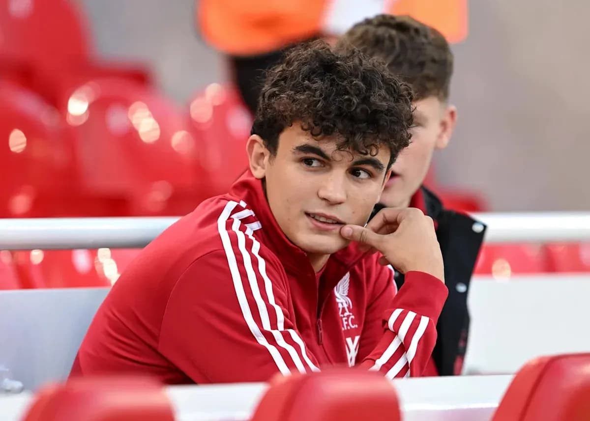 Player in Liverpool FC tracksuit on bench