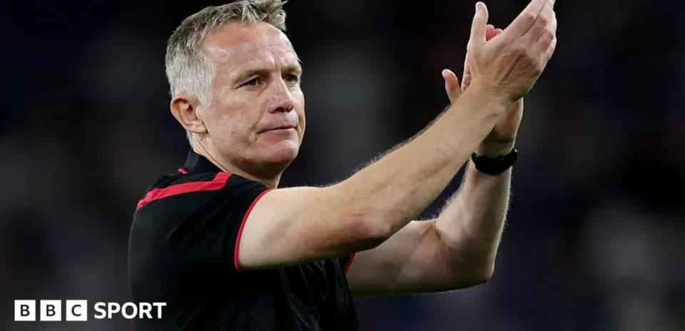 Manager applauding the crowd after the match