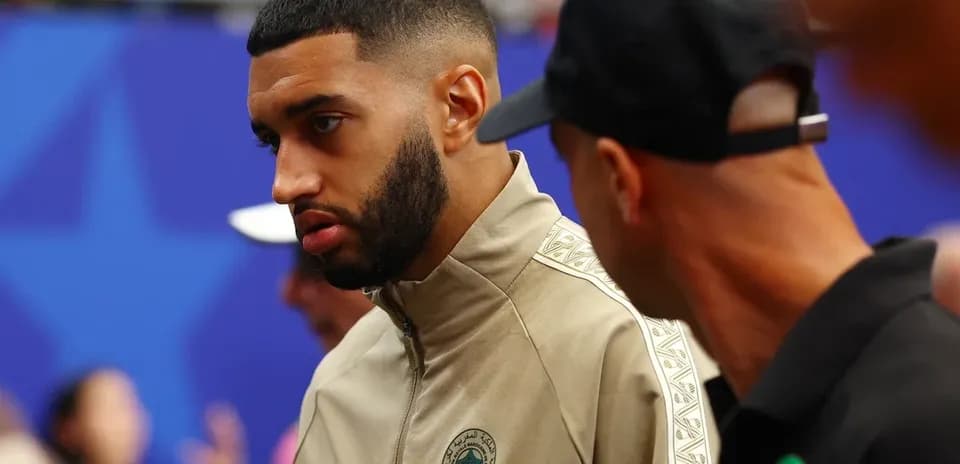 Player in Morocco team jacket interacting with others