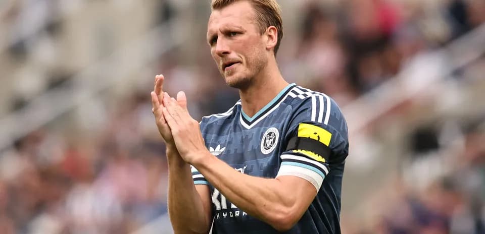 Player applauding fans during match at stadium