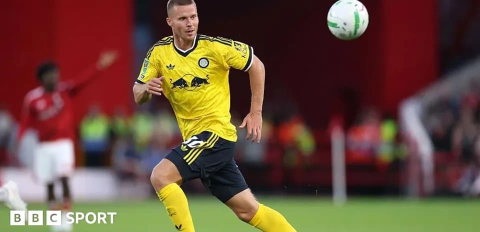 Player in yellow jersey chasing a soccer ball