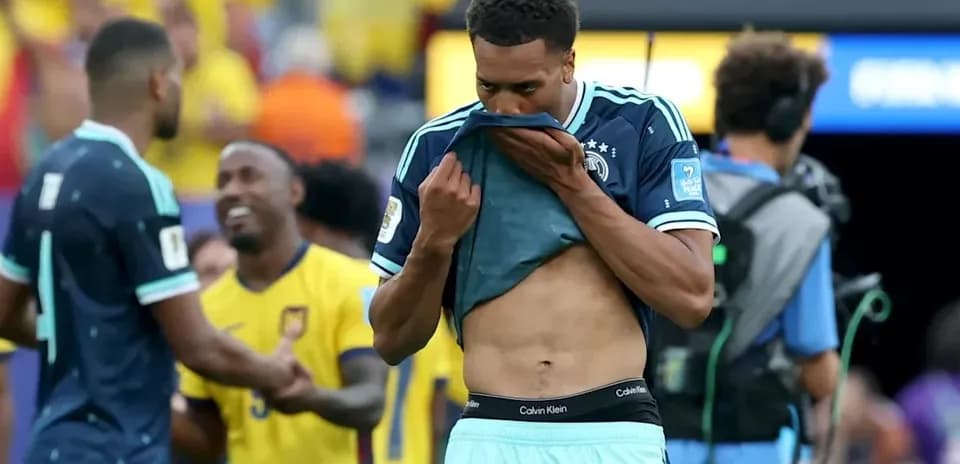 Player removing jersey after match on field