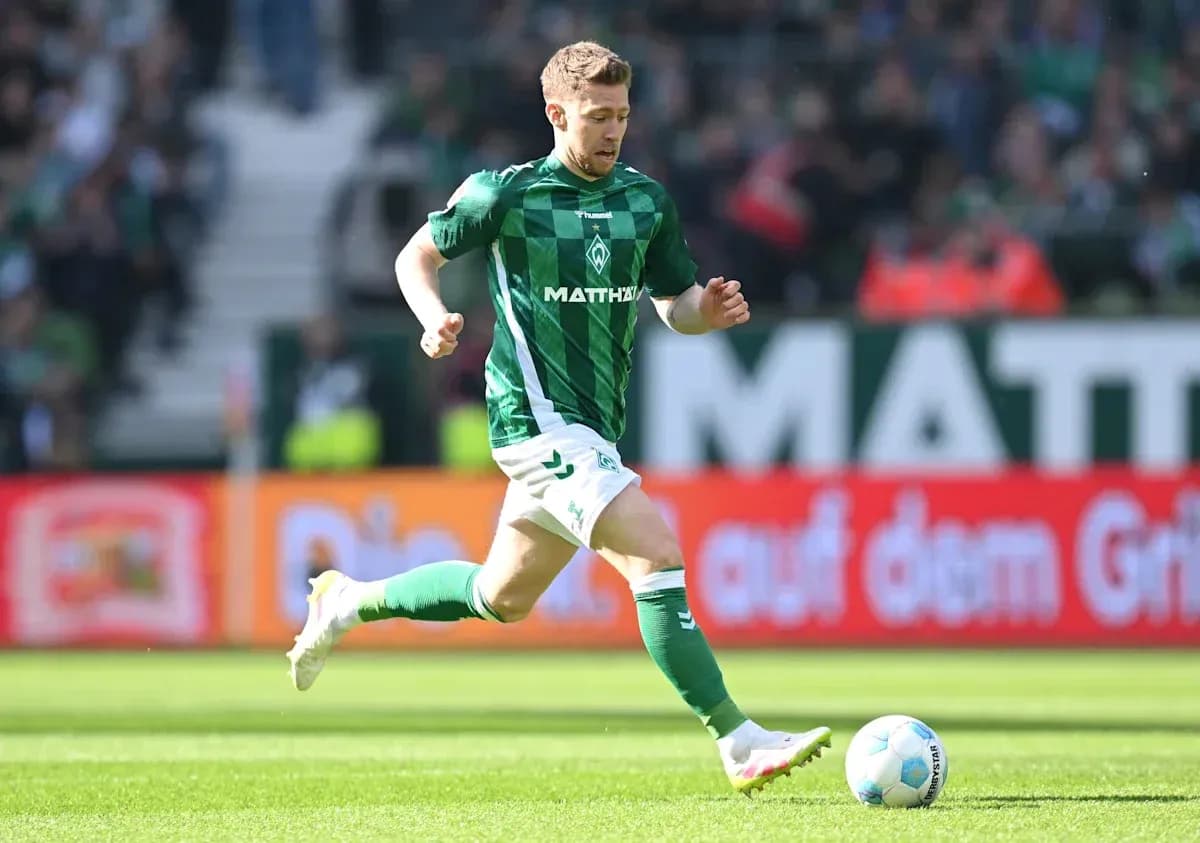 Player running with ball during match at stadium