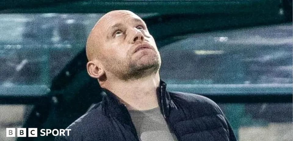Coach looking up from the sidelines during match