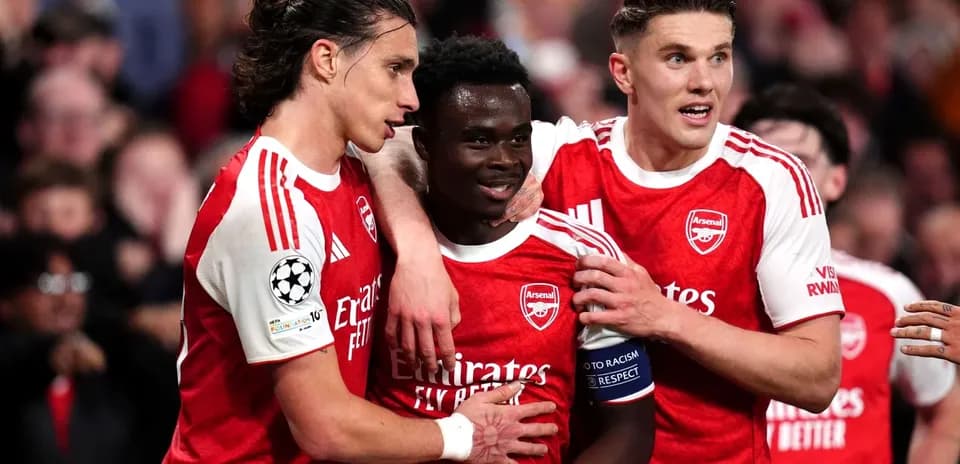 Arsenal players celebrating a goal together on pitch