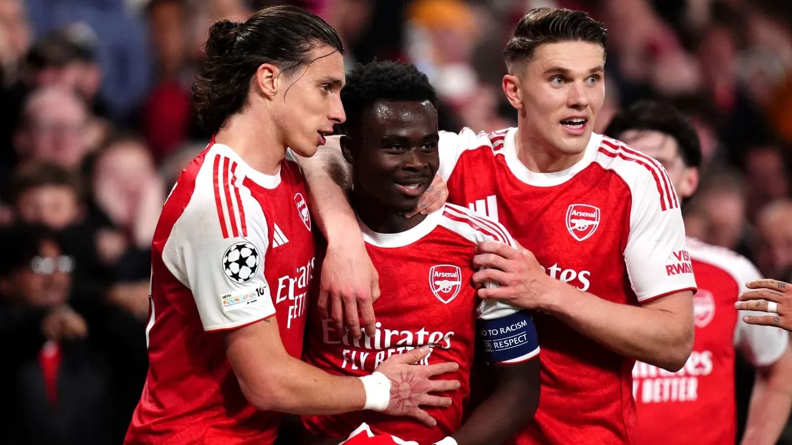 Arsenal players celebrating a goal together on pitch