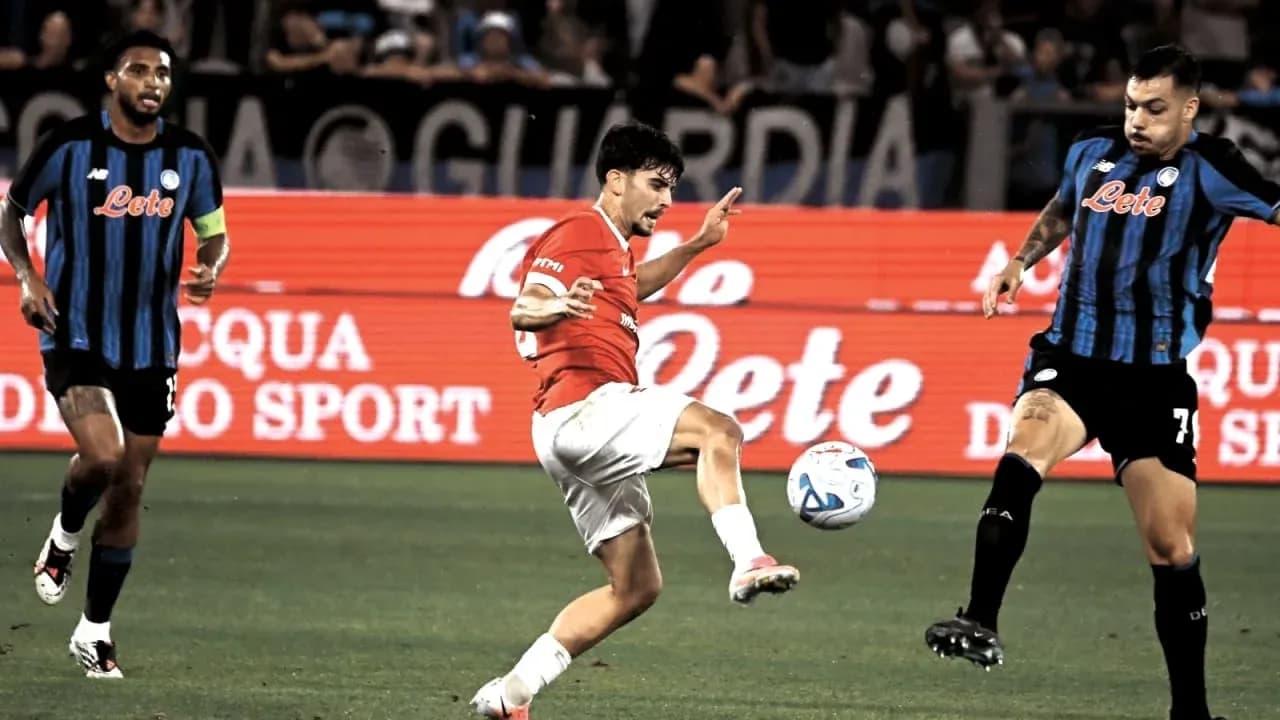 Player kicking ball during match with defenders nearby