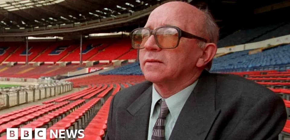 Man sitting in empty stadium seats at Wembley