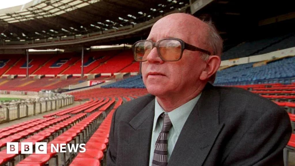 Man sitting in empty stadium seats at Wembley