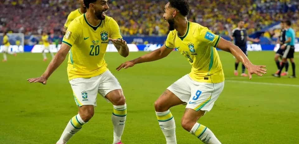Two Brazilian players celebrating a goal together