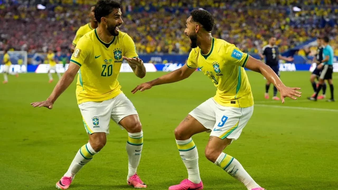 Two Brazilian players celebrating a goal together
