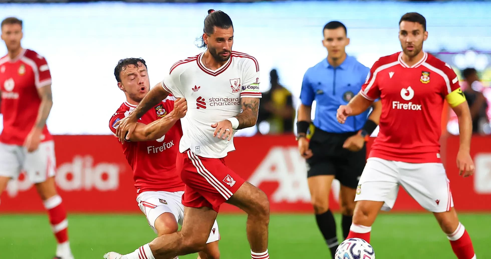 Player dribbling the ball while being challenged