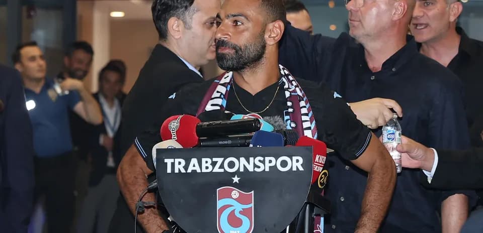 Player at press conference with Trabzonspor branding