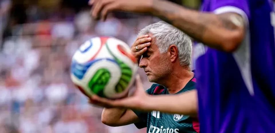 Coach with hand on forehead during match