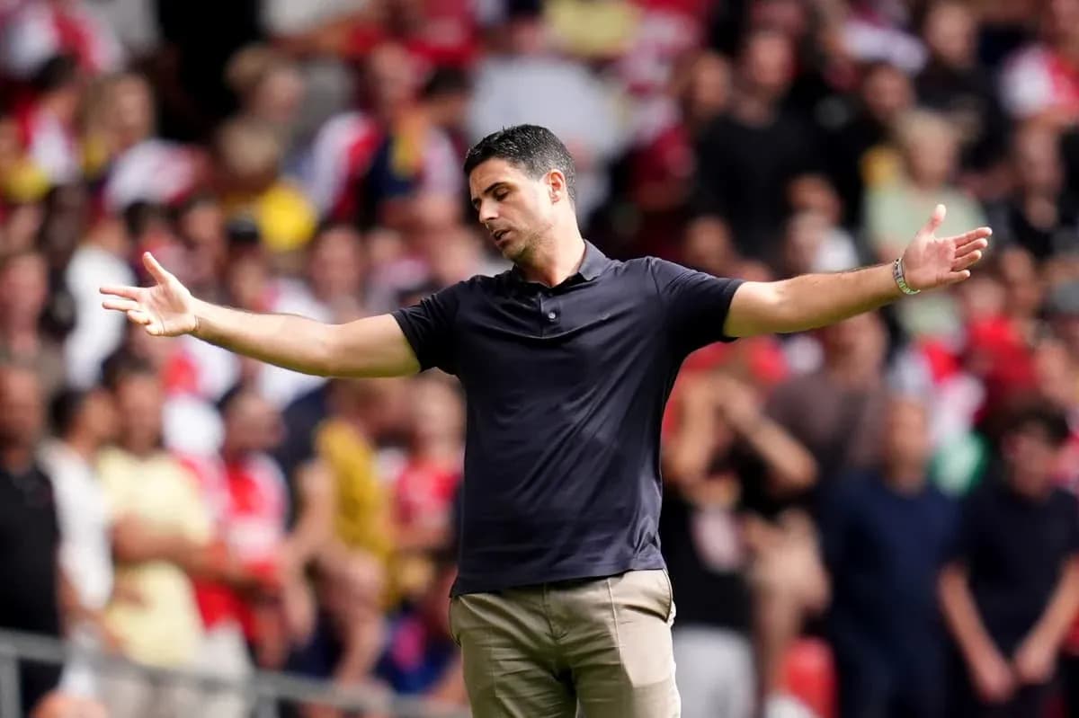 Coach gesturing during match with crowd in background
