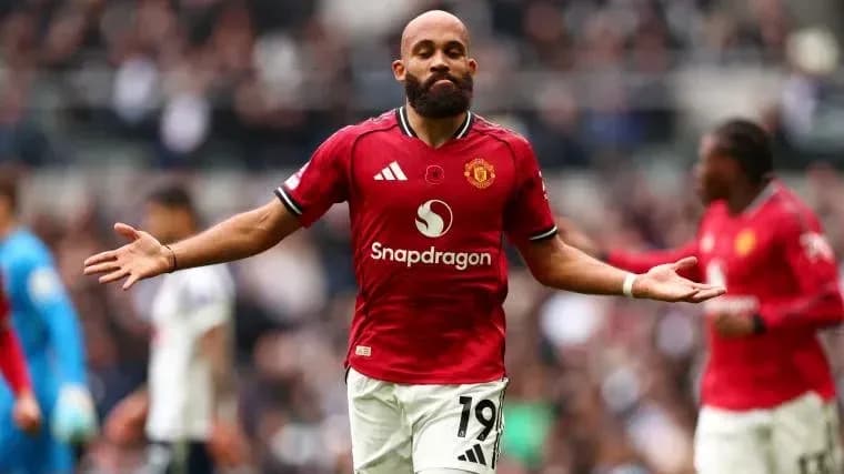 Player gesturing during a match wearing Manchester United kit