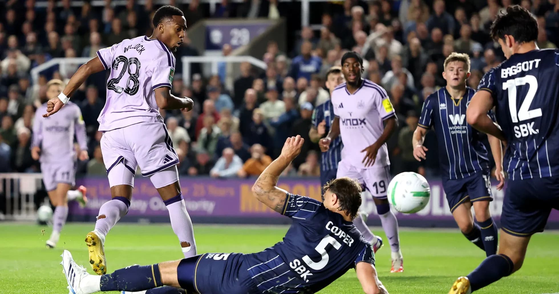 Player dribbling past defender during match action