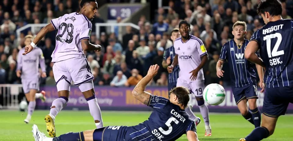 Player dribbling past defender during match action