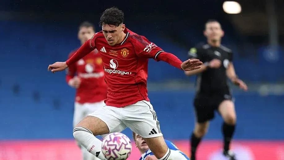 Player in red jersey falling during football match