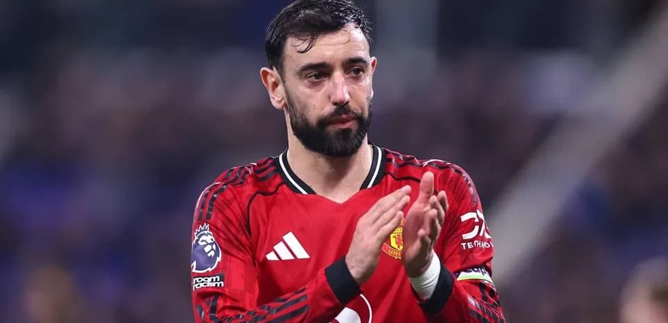 Player applauding fans in Manchester United jersey