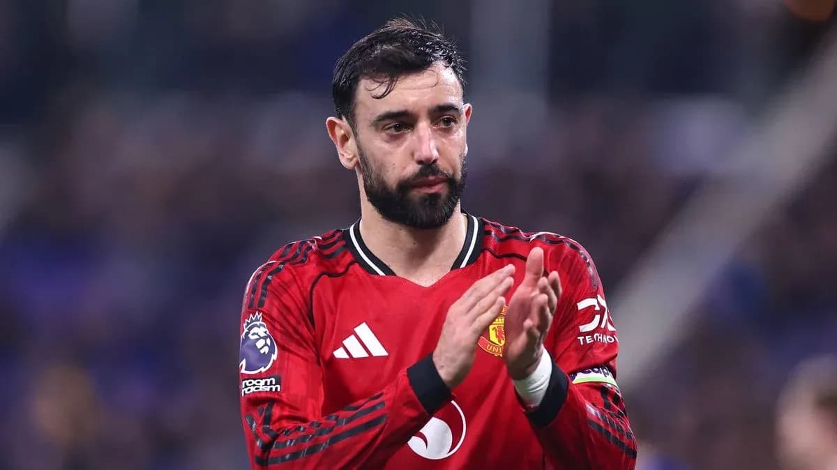 Player applauding fans in Manchester United jersey