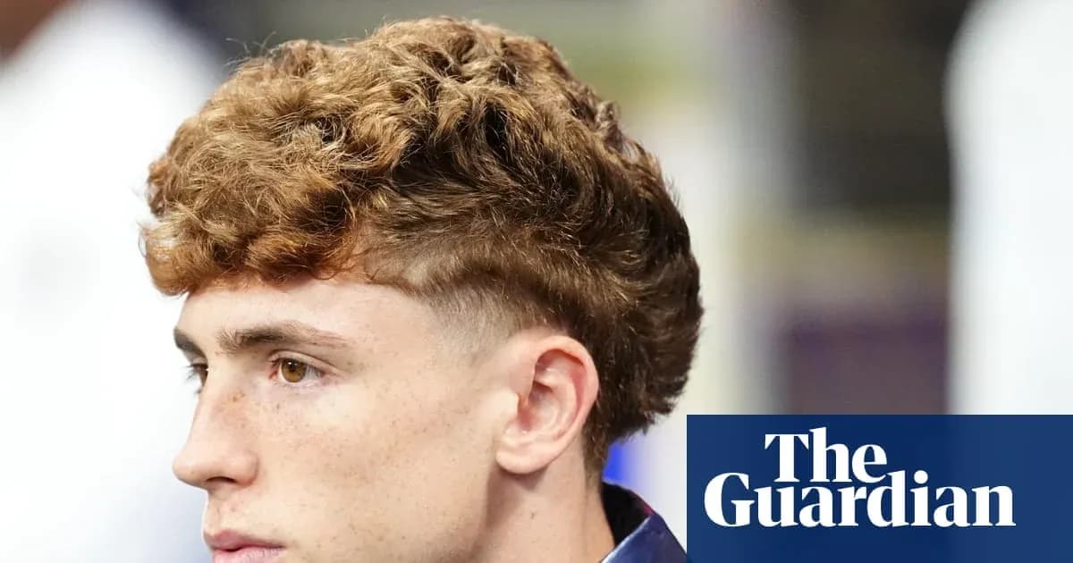 Young man with curly hair in profile view