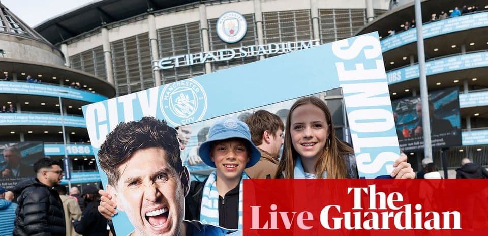Fans holding Manchester City sign outside stadium