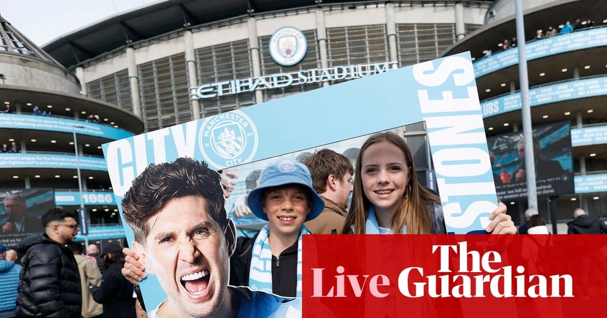 Fans holding Manchester City sign outside stadium