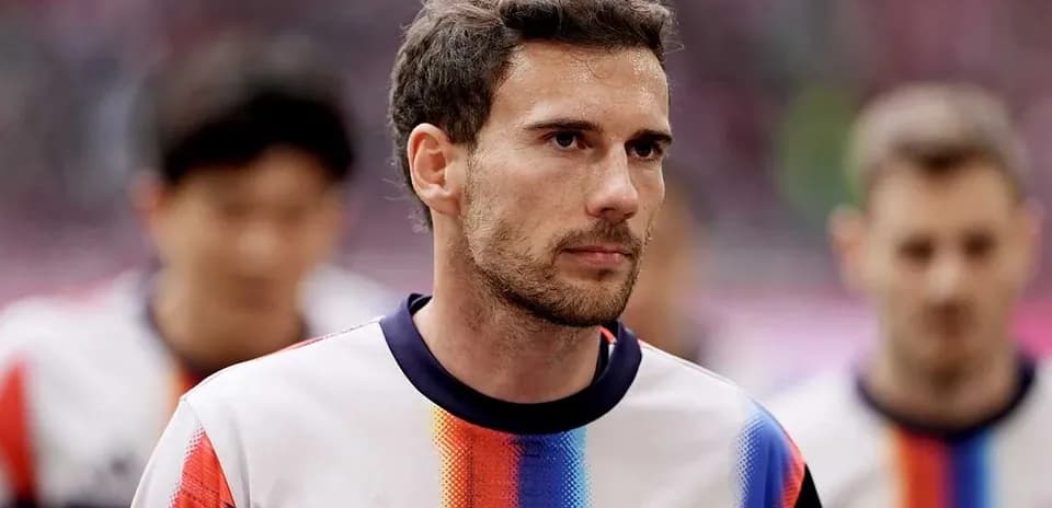 Player walking onto the pitch in team kit