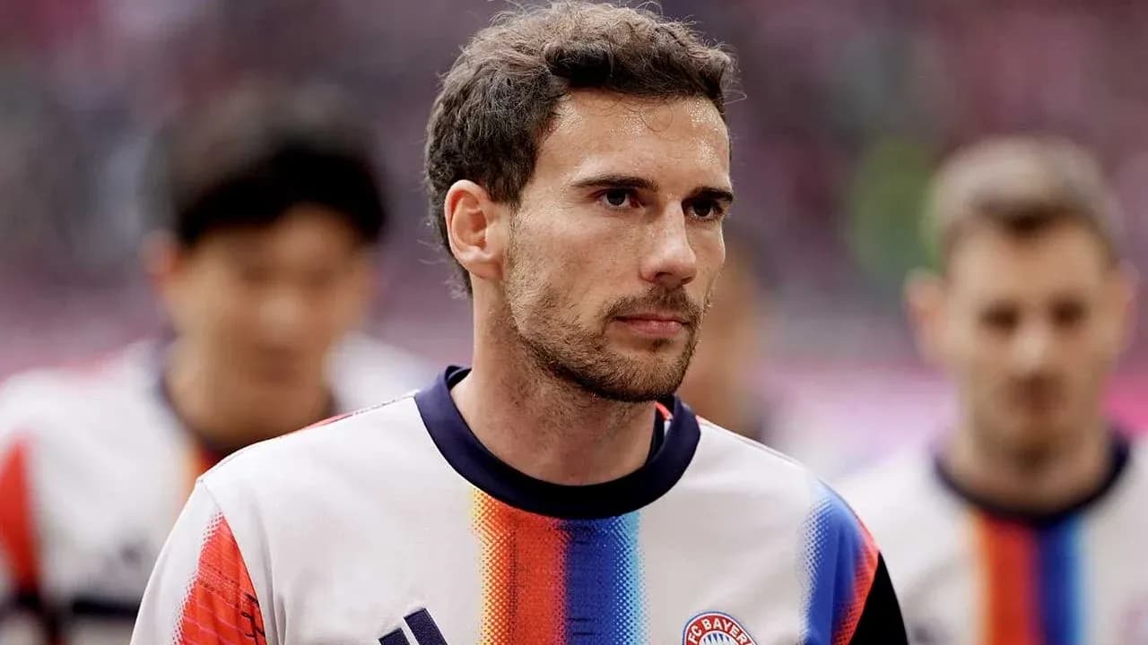 Player walking onto the pitch in team kit
