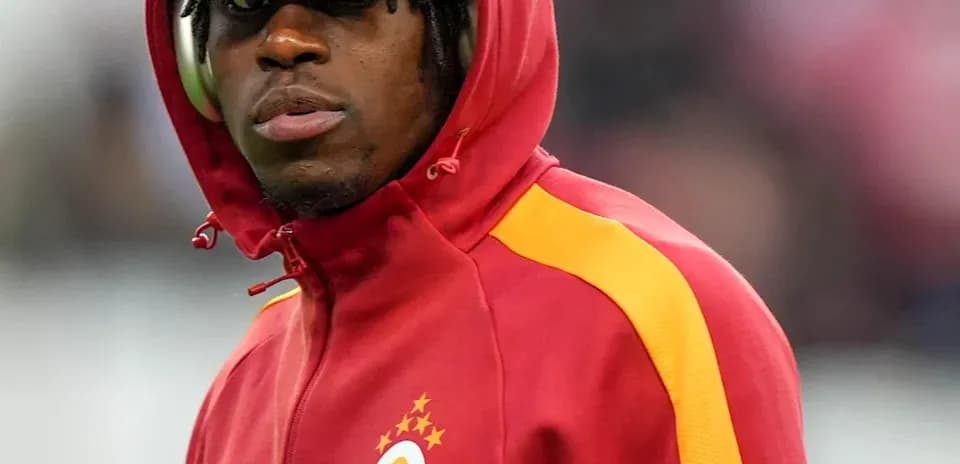 Player wearing a red hoodie with club logo