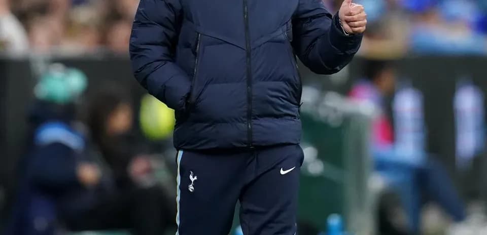 Coach walking along the sideline giving thumbs up