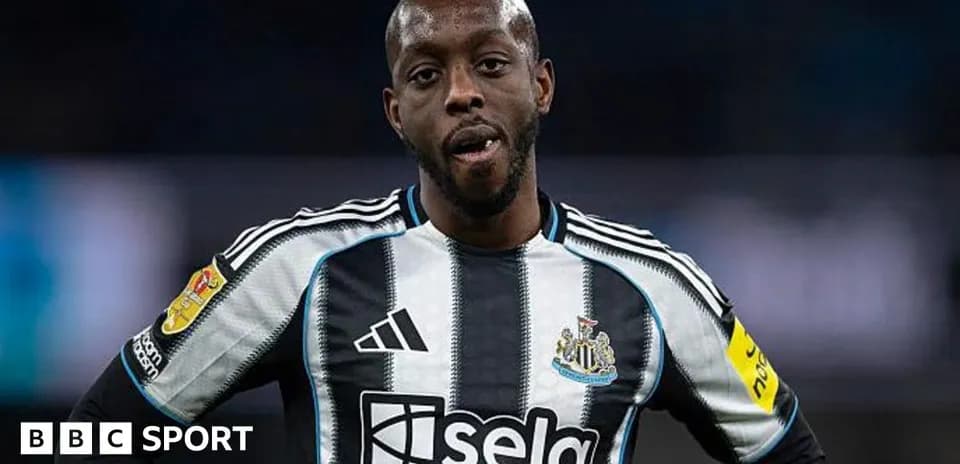 Newcastle player wearing black and white striped jersey