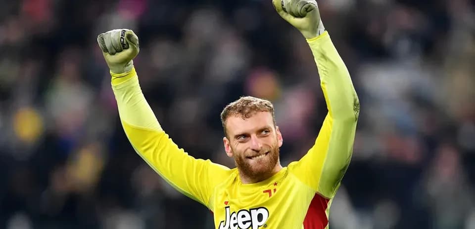 Goalkeeper celebrating victory with raised arms