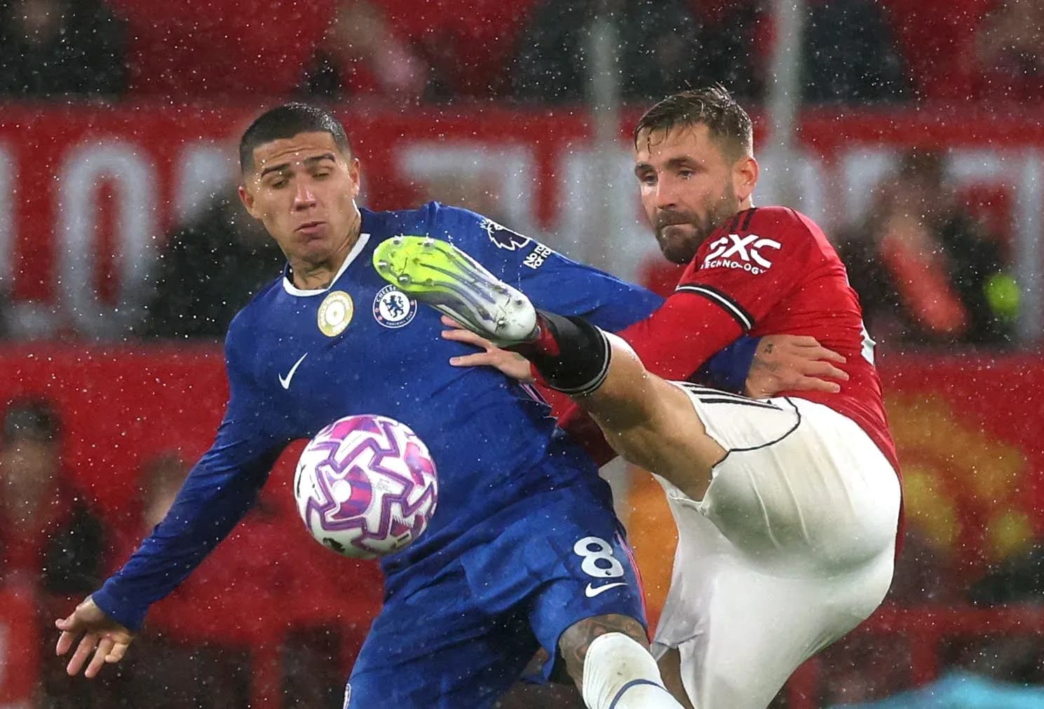 Chelsea player challenging Manchester United opponent