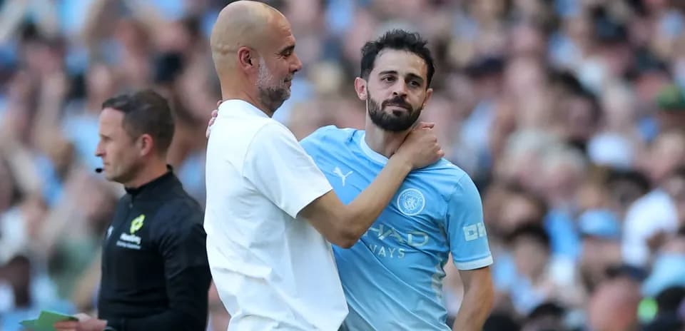Manager and player embracing during match substitution